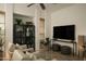 Bright living room with comfortable seating, ceiling fan, large display cabinet, and decorative woven accents at 10040 E Happy Valley Rd # 1011, Scottsdale, AZ 85255