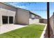 Low maintenance backyard with artificial turf and concrete patio and string lights at 1090 E Horro Rd, Queen Creek, AZ 85143