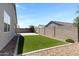 Spacious backyard with artificial grass, gravel beds, and block fencing at 1090 E Horro Rd, Queen Creek, AZ 85143