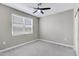 A comfortable bedroom with carpeted floors, ceiling fan and a bright window at 1090 E Horro Rd, Queen Creek, AZ 85143