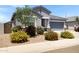Inviting single-story home featuring a two-car garage and colorful desert landscaping at 1090 E Horro Rd, Queen Creek, AZ 85143
