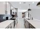 Modern kitchen features stainless steel appliances, quartz countertops, dark backsplash, and oversized single pendant lighting at 1090 E Horro Rd, Queen Creek, AZ 85143