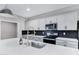 Kitchen with shaker style cabinets, stainless steel appliances, oversized sink, black subway tile backsplash, and quartz countertops at 1090 E Horro Rd, Queen Creek, AZ 85143