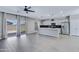 Open-concept kitchen with a large island, stainless appliances, and backyard access at 1090 E Horro Rd, Queen Creek, AZ 85143
