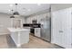 Bright kitchen features a large island with quartz countertop, black subway tile backsplash, and stainless steel appliances at 1090 E Horro Rd, Queen Creek, AZ 85143