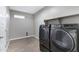 Laundry room with modern front-load washer and dryer on a tile floor at 1090 E Horro Rd, Queen Creek, AZ 85143