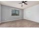 This spacious bedroom features wood plank flooring, a ceiling fan, neutral paint, and a large window at 1265 S Aaron -- # 341, Mesa, AZ 85209