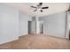 Carpeted bedroom with ceiling fan and a view into the ensuite bathroom, ready for new memories at 1265 S Aaron -- # 341, Mesa, AZ 85209