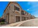 Exterior view of well-maintained townhomes featuring private garages and desert landscaping at 1265 S Aaron -- # 341, Mesa, AZ 85209
