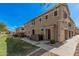 Charming townhome featuring a stucco facade, private entry, and well-maintained landscaping under a bright blue sky at 1265 S Aaron -- # 341, Mesa, AZ 85209