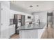 Elegant kitchen featuring white cabinets, modern appliances, gray countertop island, and stylish finishes at 1265 S Aaron -- # 341, Mesa, AZ 85209