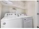 Laundry room with full size washer and dryer and a shelf for storage at 1265 S Aaron -- # 341, Mesa, AZ 85209