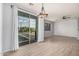 Bright living room with hardwood floors, modern lighting, large windows, and access to a private balcony at 1265 S Aaron -- # 341, Mesa, AZ 85209