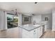 Open concept living space with modern kitchen, balcony access, plank flooring, and contemporary lighting at 1265 S Aaron -- # 341, Mesa, AZ 85209
