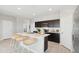 Modern kitchen with dark cabinets, stainless steel appliances, marble countertops, and a center island with seating at 1331 S Vista Ave, Florence, AZ 85132