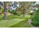 Beautifully landscaped backyard with mature trees and green lawns offering a serene and private outdoor space at 13731 W Greenview Dr, Sun City West, AZ 85375