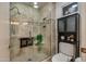 Clean modern bathroom with glass shower, tiled walls, and black fixtures and storage at 13731 W Greenview Dr, Sun City West, AZ 85375
