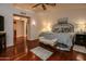 Spacious bedroom with sitting area and hardwood floors leads to adjoining bathroom at 13731 W Greenview Dr, Sun City West, AZ 85375