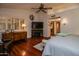 Large bedroom with hardwood floors, ceiling fan and shuttered windows provides natural light at 13731 W Greenview Dr, Sun City West, AZ 85375