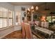 A dining room featuring a glass-top table, upholstered chairs, and a decorative chandelier provides an elegant space at 13731 W Greenview Dr, Sun City West, AZ 85375