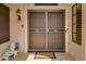 Close-up of the front door, featuring a security screen door and decorative details at 13731 W Greenview Dr, Sun City West, AZ 85375