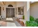 Inviting front entrance features a security screen door, bench, and desert landscaping at 13731 W Greenview Dr, Sun City West, AZ 85375