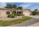 Charming single-story home with desert landscaping, lush greenery, and a two-car garage at 13731 W Greenview Dr, Sun City West, AZ 85375