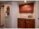 Hallway cabinet storage area, featuring wooden cabinets and a decorative mirror at 13731 W Greenview Dr, Sun City West, AZ 85375