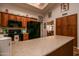 Traditional kitchen featuring wooden cabinets, black appliances, and a beige countertop with decor at 13731 W Greenview Dr, Sun City West, AZ 85375