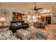 This spacious living room has tiled floors, patterned sofas, and easy access to the kitchen and dining area at 13731 W Greenview Dr, Sun City West, AZ 85375