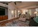 Bright living room with shuttered windows, patterned seating, and an entertainment center at 13731 W Greenview Dr, Sun City West, AZ 85375