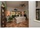 Cozy living room with tile flooring, high ceilings, and sliding glass doors to the patio at 13731 W Greenview Dr, Sun City West, AZ 85375