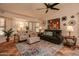 Charming living room with decorative accents, ample seating, and a ceiling fan at 13731 W Greenview Dr, Sun City West, AZ 85375
