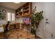 Cozy office space with built in wood cabinets and drawers, decorative shelving, and tiled floor at 13731 W Greenview Dr, Sun City West, AZ 85375