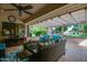 Inviting covered patio with comfortable seating, ceiling fan, and serene outdoor views at 13731 W Greenview Dr, Sun City West, AZ 85375