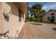 Paver walkway along the side of the home, surrounded by desert landscaping and lush greenery at 13731 W Greenview Dr, Sun City West, AZ 85375