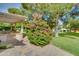 Pathway to covered patio with lush landscaping, shrubs and trees at 13731 W Greenview Dr, Sun City West, AZ 85375