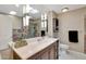Bathroom featuring double sinks, decorative tile backsplash, and updated fixtures at 13806 N Del Webb Blvd, Sun City, AZ 85351