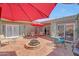 A beautiful covered patio with a fire pit and outdoor furniture providing a comfortable and inviting space at 13806 N Del Webb Blvd, Sun City, AZ 85351