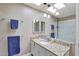 Bright bathroom featuring a granite countertop vanity and a large mirror with accent lighting at 13806 N Del Webb Blvd, Sun City, AZ 85351