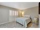 Inviting bedroom with white shutters, a queen bed, and comfortable seating at 13806 N Del Webb Blvd, Sun City, AZ 85351
