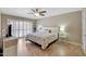Bedroom featuring a patterned bedspread, ceiling fan and window shutters for privacy at 13806 N Del Webb Blvd, Sun City, AZ 85351