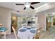 A dining room with a table and chairs, light wood floor, and a ceiling fan at 13806 N Del Webb Blvd, Sun City, AZ 85351