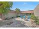 Inviting courtyard featuring a charming water fountain and a small sitting area with blue Adirondack chairs at 13806 N Del Webb Blvd, Sun City, AZ 85351