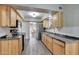 Kitchen features wood cabinets, stainless steel fridge, and tile backsplash at 13806 N Del Webb Blvd, Sun City, AZ 85351