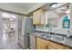Kitchen features stainless steel appliances, light wood cabinets, and a view to the dining room at 13806 N Del Webb Blvd, Sun City, AZ 85351