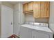 Laundry room with washer, dryer, and storage cabinets at 13806 N Del Webb Blvd, Sun City, AZ 85351