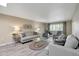 Bright living room with ample seating, modern decor, and a view of the landscaped surroundings at 13806 N Del Webb Blvd, Sun City, AZ 85351