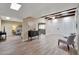 Open living room with exposed beams, modern flooring, and seamless transition to other living spaces at 13806 N Del Webb Blvd, Sun City, AZ 85351