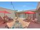 Backyard featuring a patio, a fire pit, seating, grill, and updated fixtures at 13806 N Del Webb Blvd, Sun City, AZ 85351